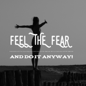Woman holding her hands out against the wind with text "FEEL THE FEAR AND DO IT ANYWAY!"